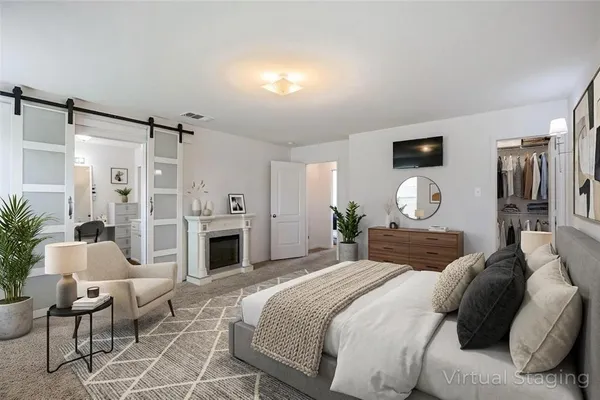 a large bedroom with a bed and a fireplace