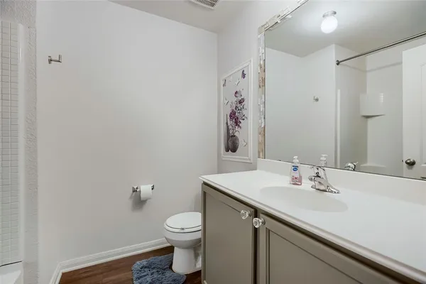 a bathroom with a sink a toilet and mirror