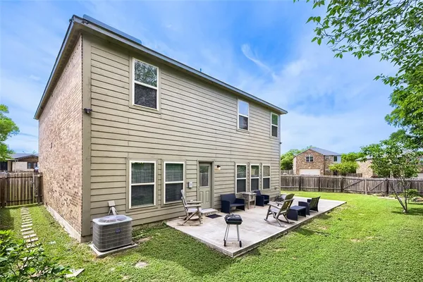 a view of a patio with couches and a potted plant on a table
