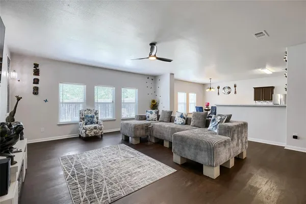 a living room with furniture fireplace and a window