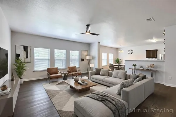 a living room with furniture wooden floor and a flat screen tv