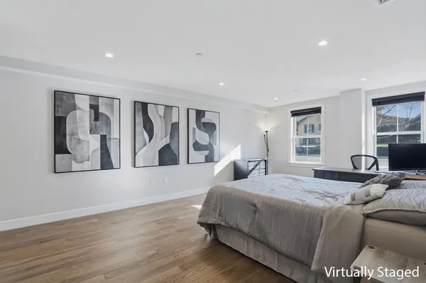 a bedroom with a large bed and a large window