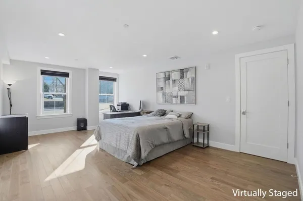 a spacious bedroom with a bed and a couch