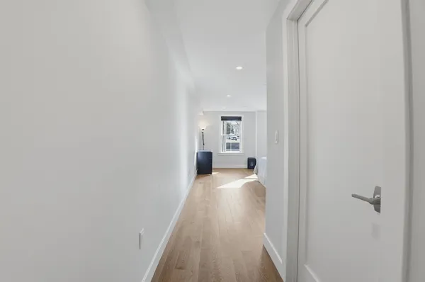 a view of a bedroom with wooden floor