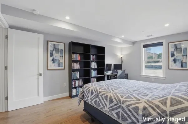 a bedroom with a large bed and a window