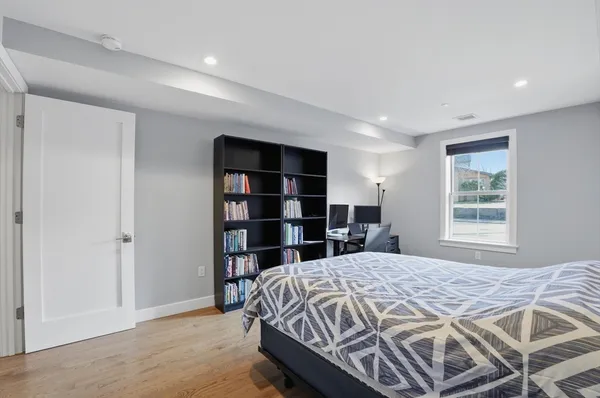 a bedroom with a bed furniture and a flat screen tv