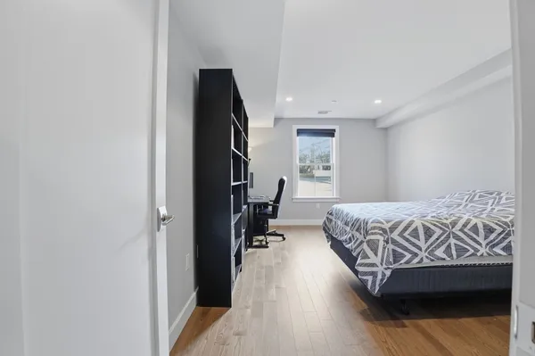 a bedroom with a bed and a night stand