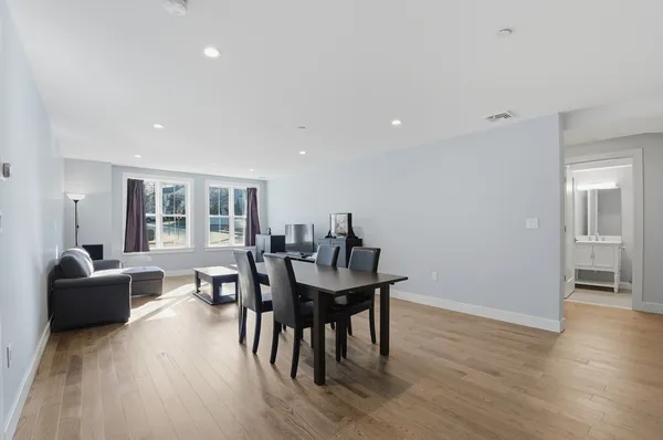 a view of a dining room with furniture and wooden floor