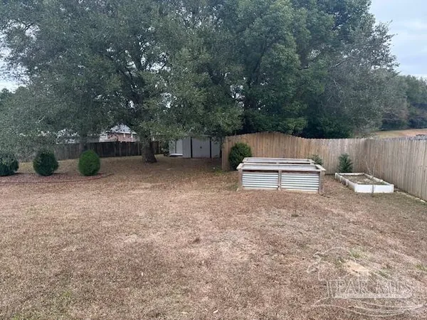 a backyard of a house with wooden fence