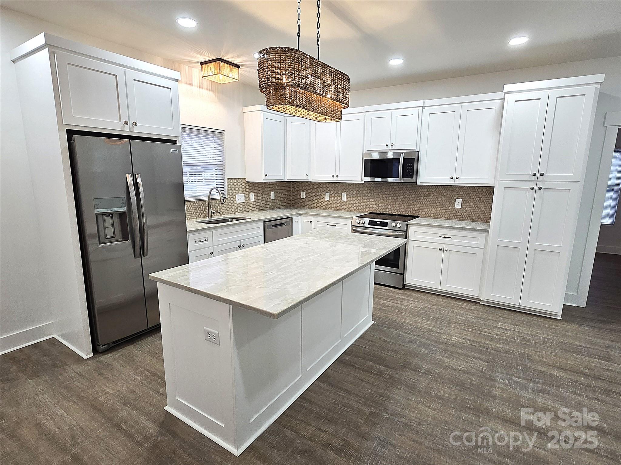 768 8th Street Northeast Hickory, NC 28601 - Photo 5 of 21 a kitchen with stainless steel appliances granite countertop a refrigerator a stove a sink and white cabinets