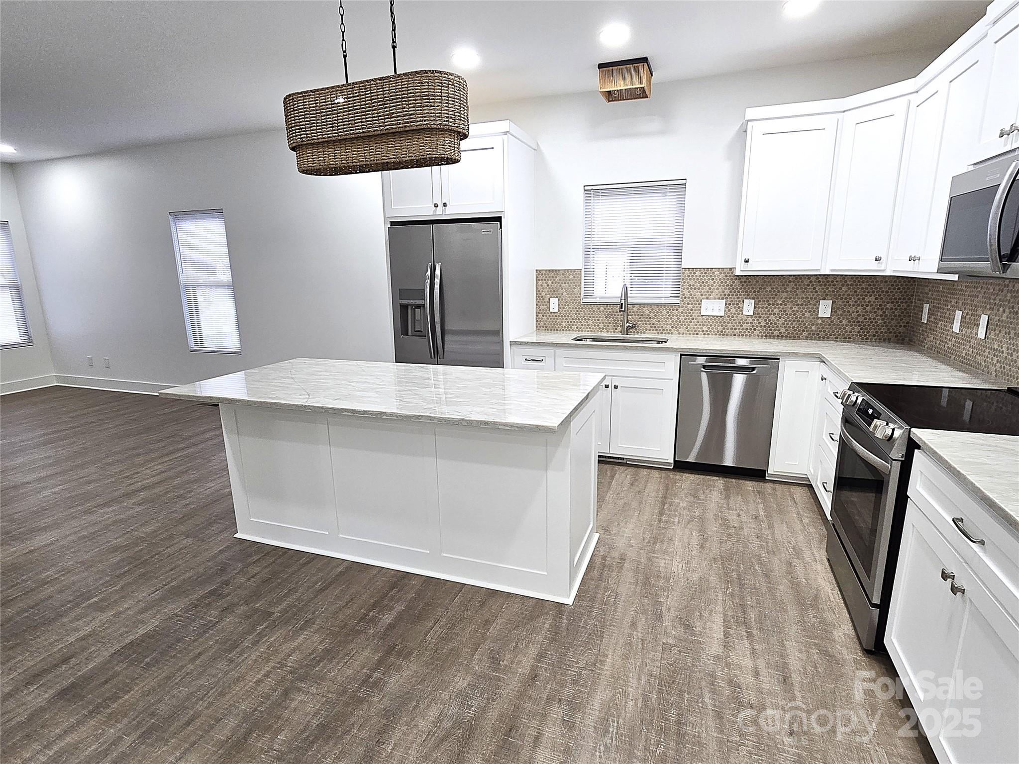768 8th Street Northeast Hickory, NC 28601 - Photo 6 of 21 a large kitchen with cabinets wooden floor and stainless steel appliances