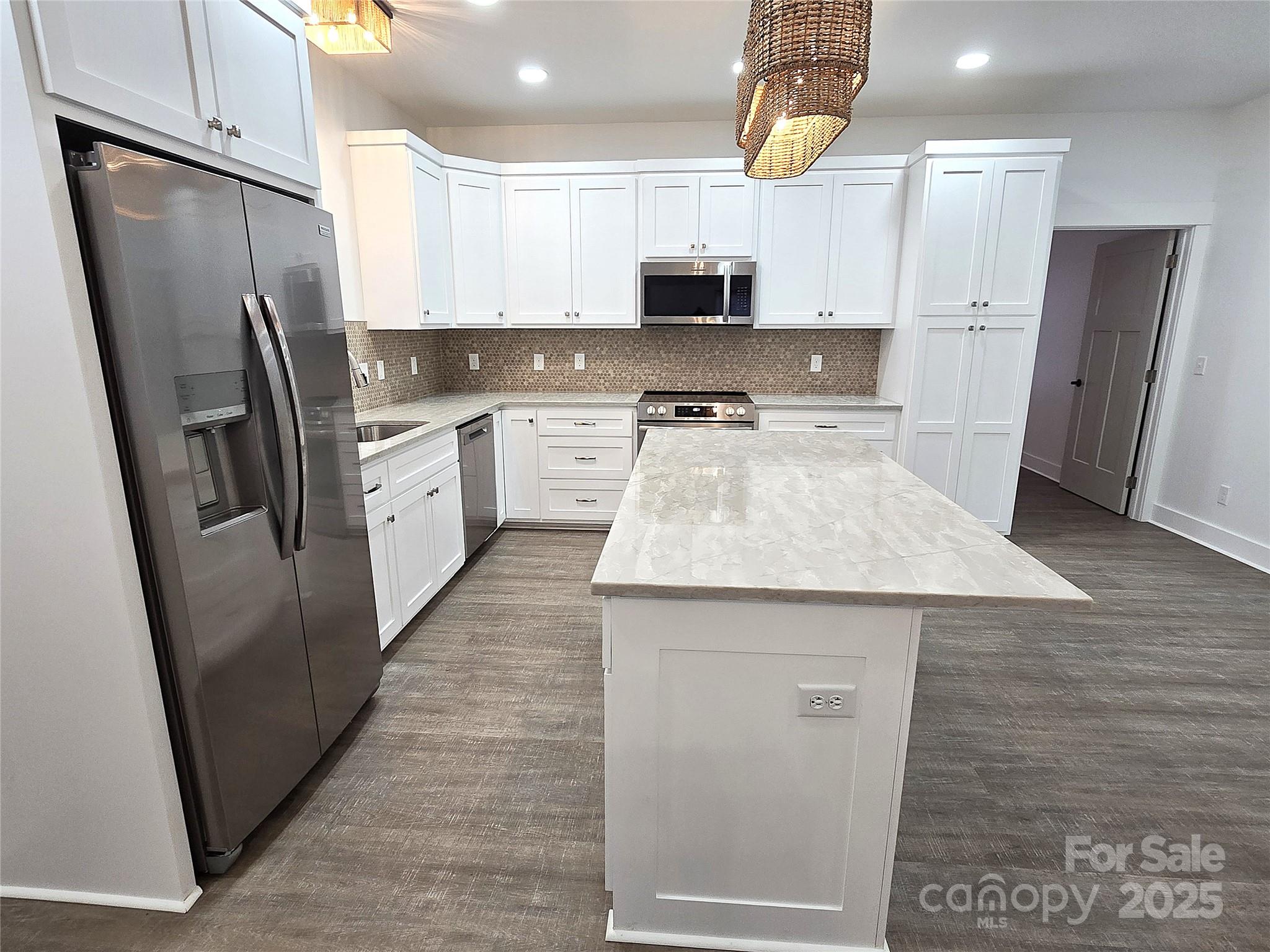 768 8th Street Northeast Hickory, NC 28601 - Photo 8 of 21 a kitchen with stainless steel appliances a refrigerator sink and microwave
