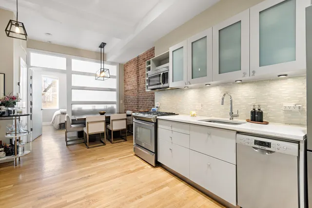 a kitchen with stainless steel appliances granite countertop a sink and cabinets
