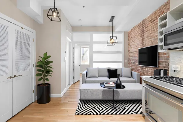 a living room with furniture a flat screen tv and a fireplace