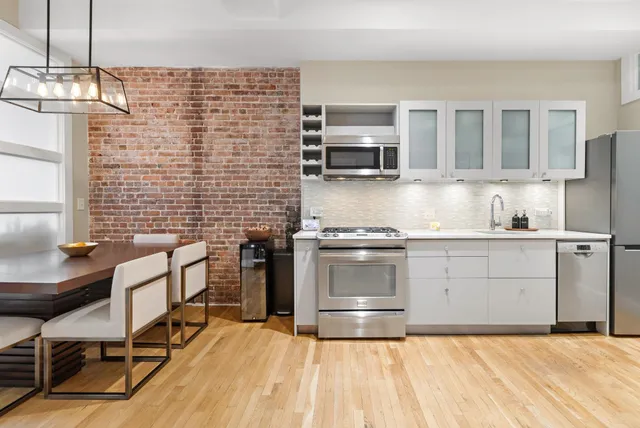 a kitchen with a sink appliances and cabinets