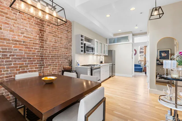 a kitchen with stainless steel appliances granite countertop a sink dishwasher stove refrigerator and cabinets