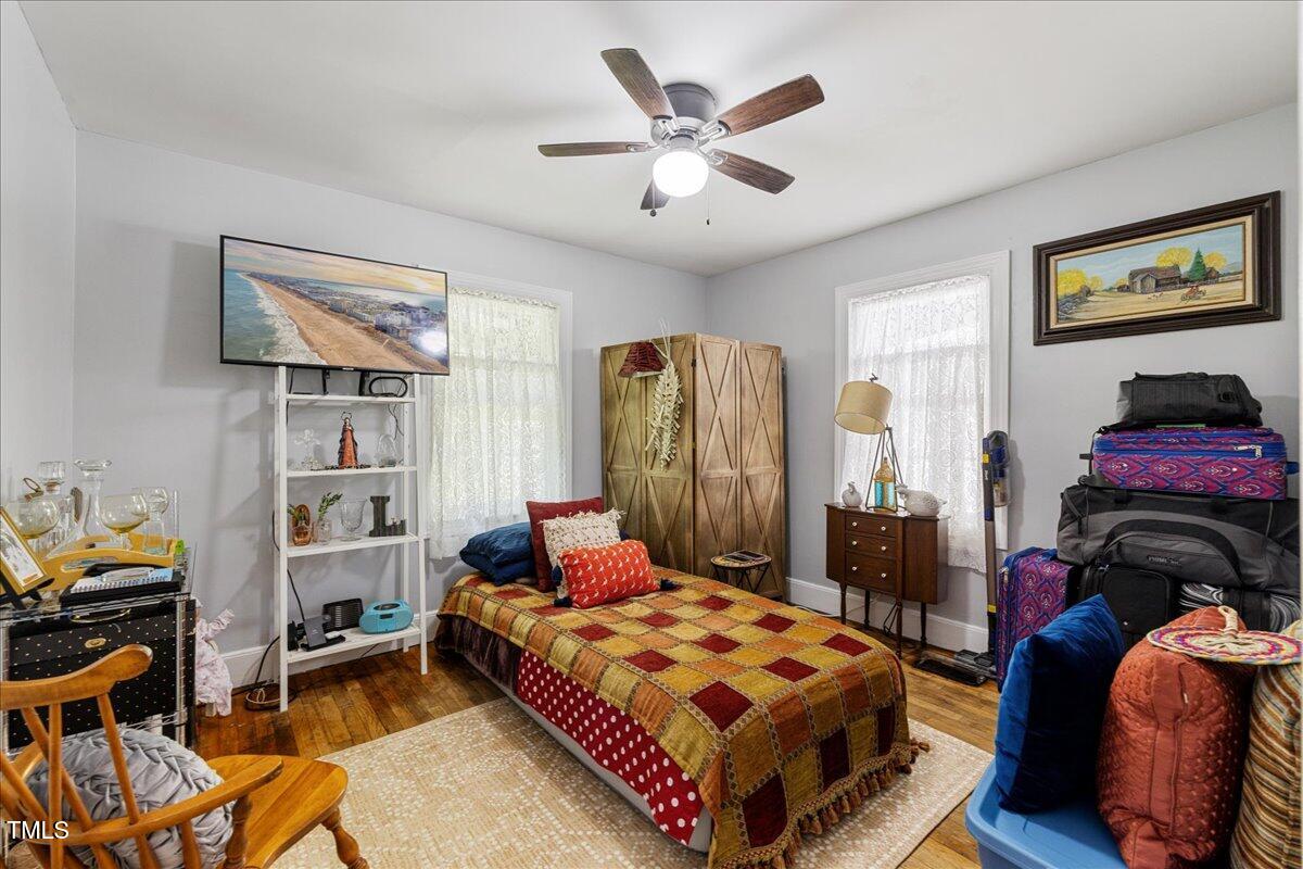 415 Edward Street Durham, NC 27701 - Photo 13 of 27 a bedroom with a bed and a chandelier