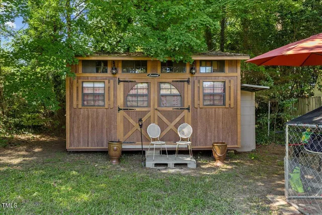 a backyard of a house with table and chairs