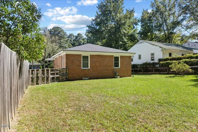 a view of a house with a yard and sitting area