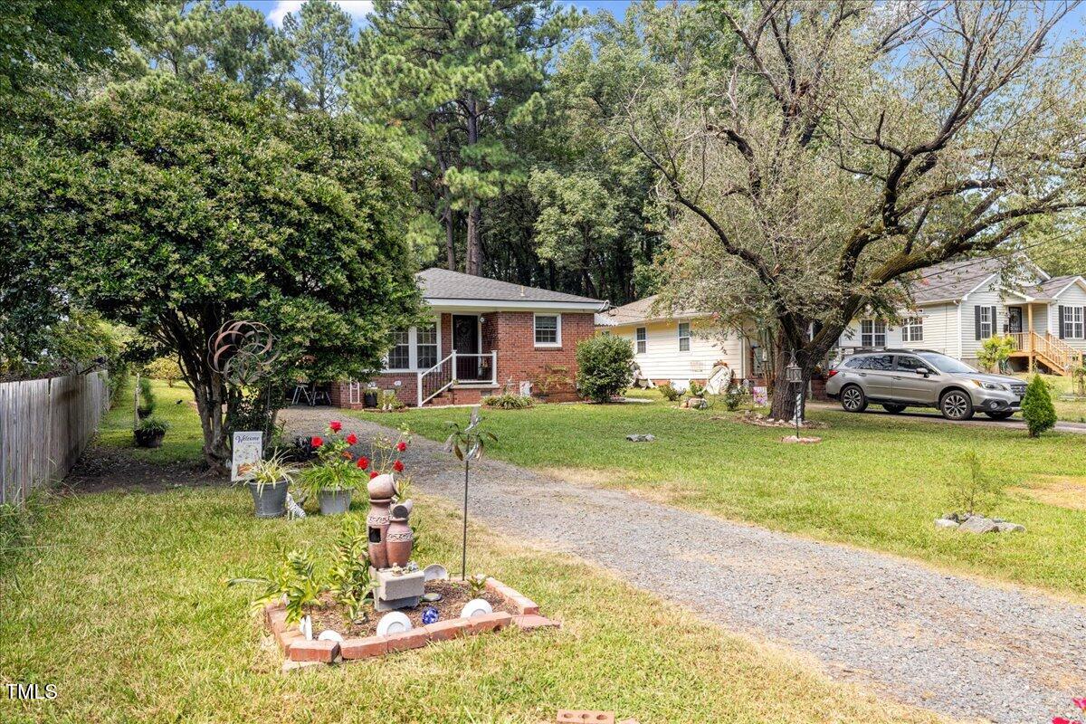 415 Edward Street Durham, NC 27701 - Photo 2 of 27 a front view of a house with a yard table and chairs