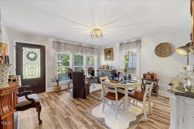 a view of a dining room with furniture a chandelier and wooden floor