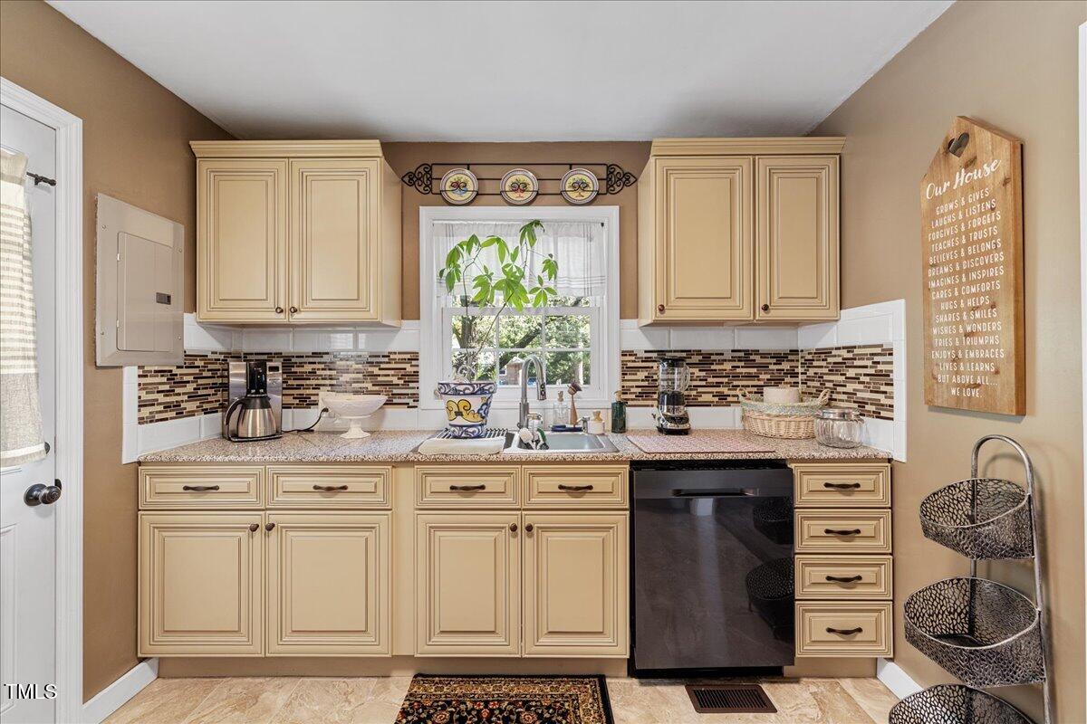 415 Edward Street Durham, NC 27701 - Photo 8 of 27 a kitchen with stainless steel appliances granite countertop a sink stove and cabinets