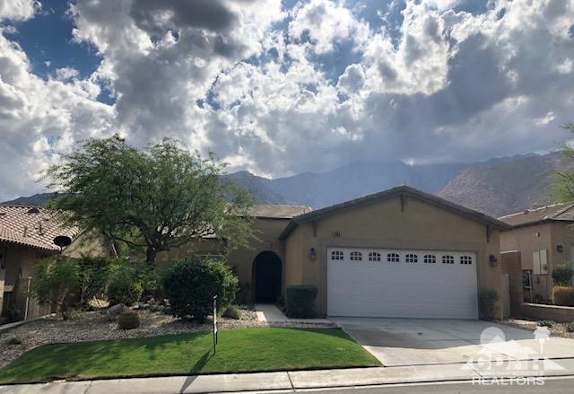 1255 Palmas Ridge Palm Springs, CA 92262 - Photo 1 of 34 a front view of a house with garden