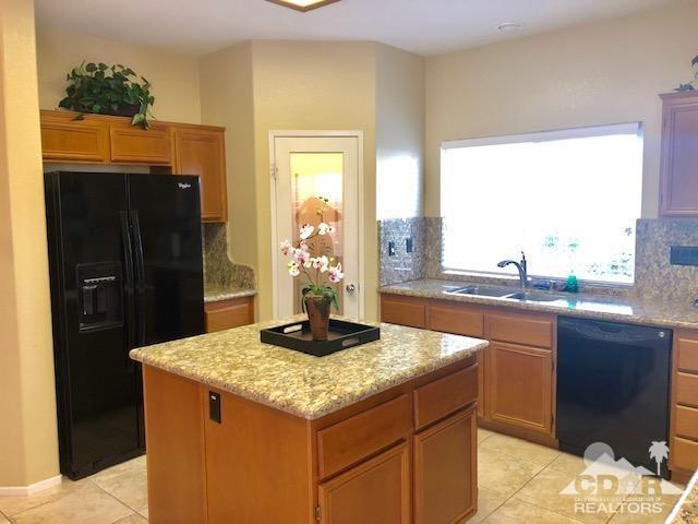 1255 Palmas Ridge Palm Springs, CA 92262 - Photo 11 of 34 a kitchen with a sink a refrigerator and a window