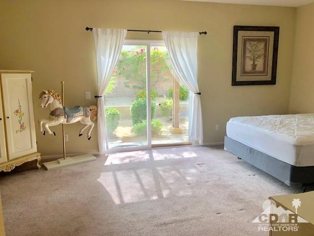 1255 Palmas Ridge Palm Springs, CA 92262 - Photo 14 of 34 a bedroom with a bed and a large window