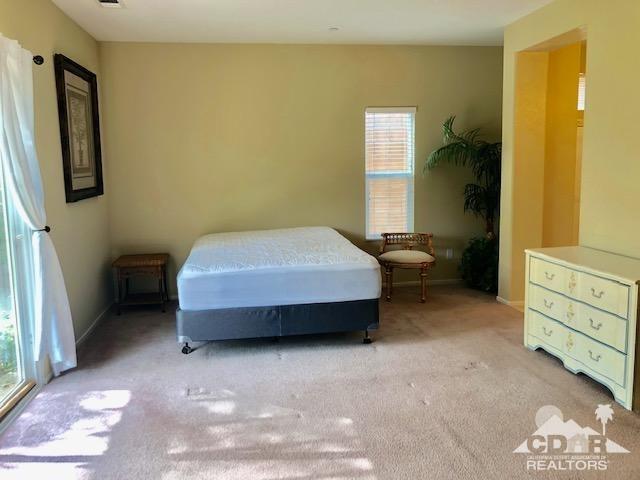1255 Palmas Ridge Palm Springs, CA 92262 - Photo 15 of 34 a bedroom with a bed and a cabinets