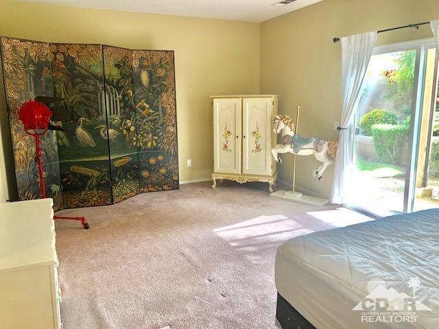 1255 Palmas Ridge Palm Springs, CA 92262 - Photo 16 of 34 a bedroom with a bed and a window