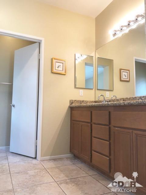 1255 Palmas Ridge Palm Springs, CA 92262 - Photo 19 of 34 a bathroom with a granite countertop sink and a mirror