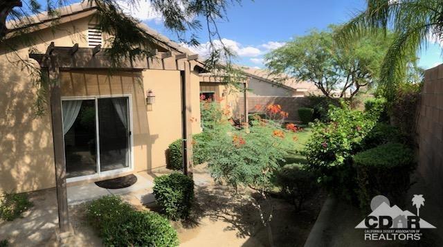 1255 Palmas Ridge Palm Springs, CA 92262 - Photo 28 of 34 a front view of a house with garden