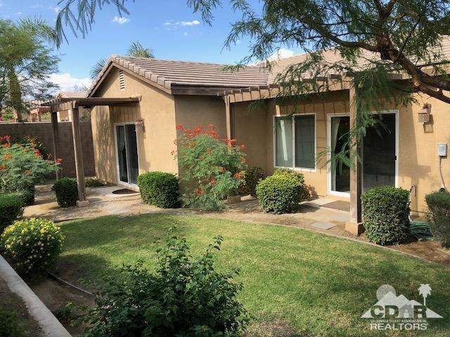 1255 Palmas Ridge Palm Springs, CA 92262 - Photo 30 of 34 a front view of a house with a garden