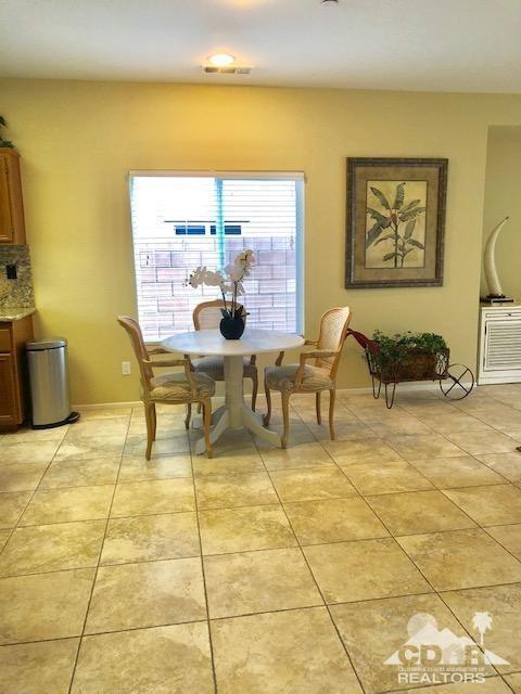 1255 Palmas Ridge Palm Springs, CA 92262 - Photo 7 of 34 a dining room with furniture and a floor to ceiling window