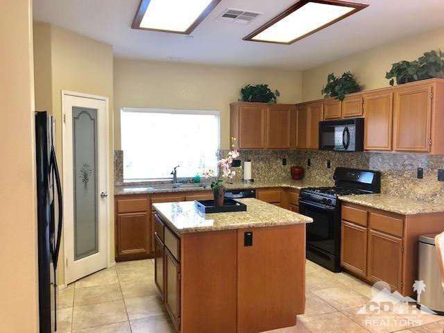 1255 Palmas Ridge Palm Springs, CA 92262 - Photo 8 of 34 a kitchen with stainless steel appliances granite countertop a stove a sink and a refrigerator