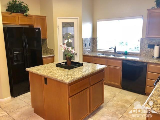 1255 Palmas Ridge Palm Springs, CA 92262 - Photo 9 of 34 a kitchen with a sink a refrigerator and a stove top oven