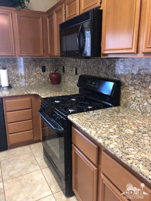 1255 Palmas Ridge Palm Springs, CA 92262 - Photo 10 of 34 a kitchen with granite countertop a stove and a sink
