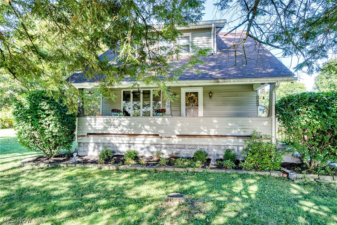 5840 Poland Struthers Road Youngstown, OH 44514 - Photo 2 of 50 Siding exterior with a covered porch, established landscaping, and a pitched roof