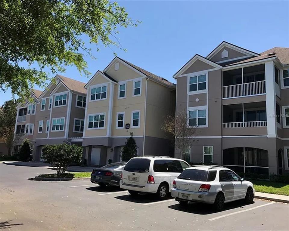 3468 Soho Street, Unit 202 Orlando, FL 32835 - Photo 1 of 1 a car parked in front of a building