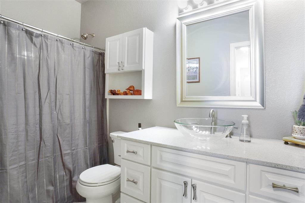 13340 John Day Road Haslet, TX 76052 - Photo 21 of 30 a bathroom with a sink a toilet and shower curtain