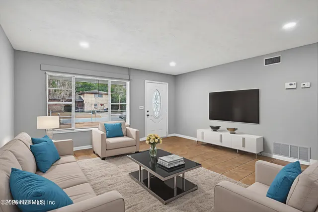 a living room with furniture and a flat screen tv