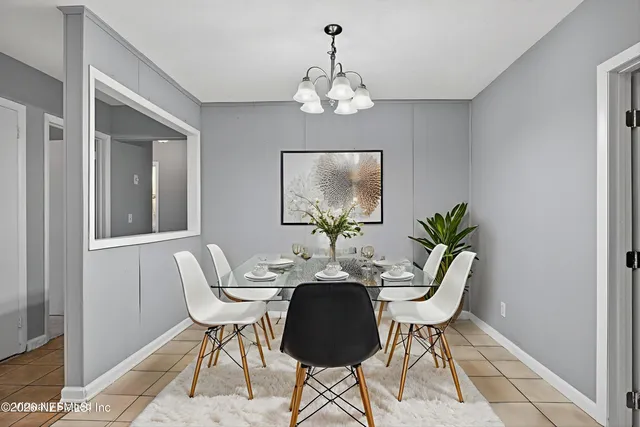 a dining room with furniture and chandelier