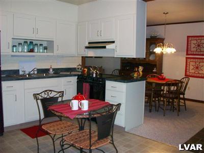 545 Clearfield Road Nazareth, PA 18064 - Photo 2 of 11 a view of a dining room with furniture and chandelier