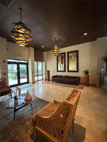 a living room with patio furniture and a wooden floor