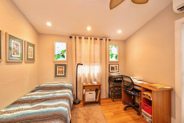 1218 Packer Street, Unit REAR Key West, FL 33040 - Photo 12 of 22 a bedroom with a bed and wooden floor