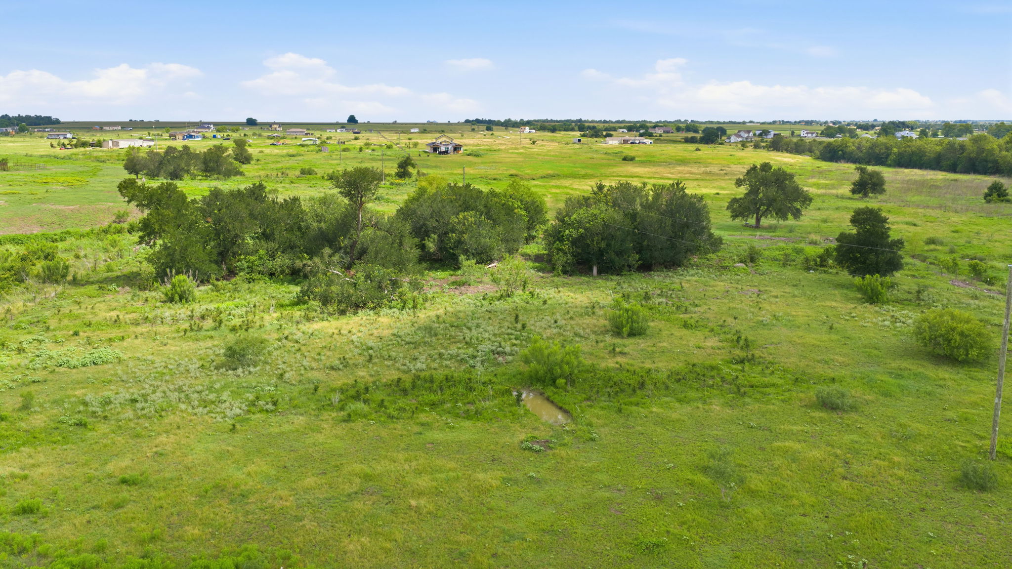 1701 County Road 466 Elgin, TX 78621 - Photo 23 of 24 A verdant, open lot offers a serene setting for your next dream home.