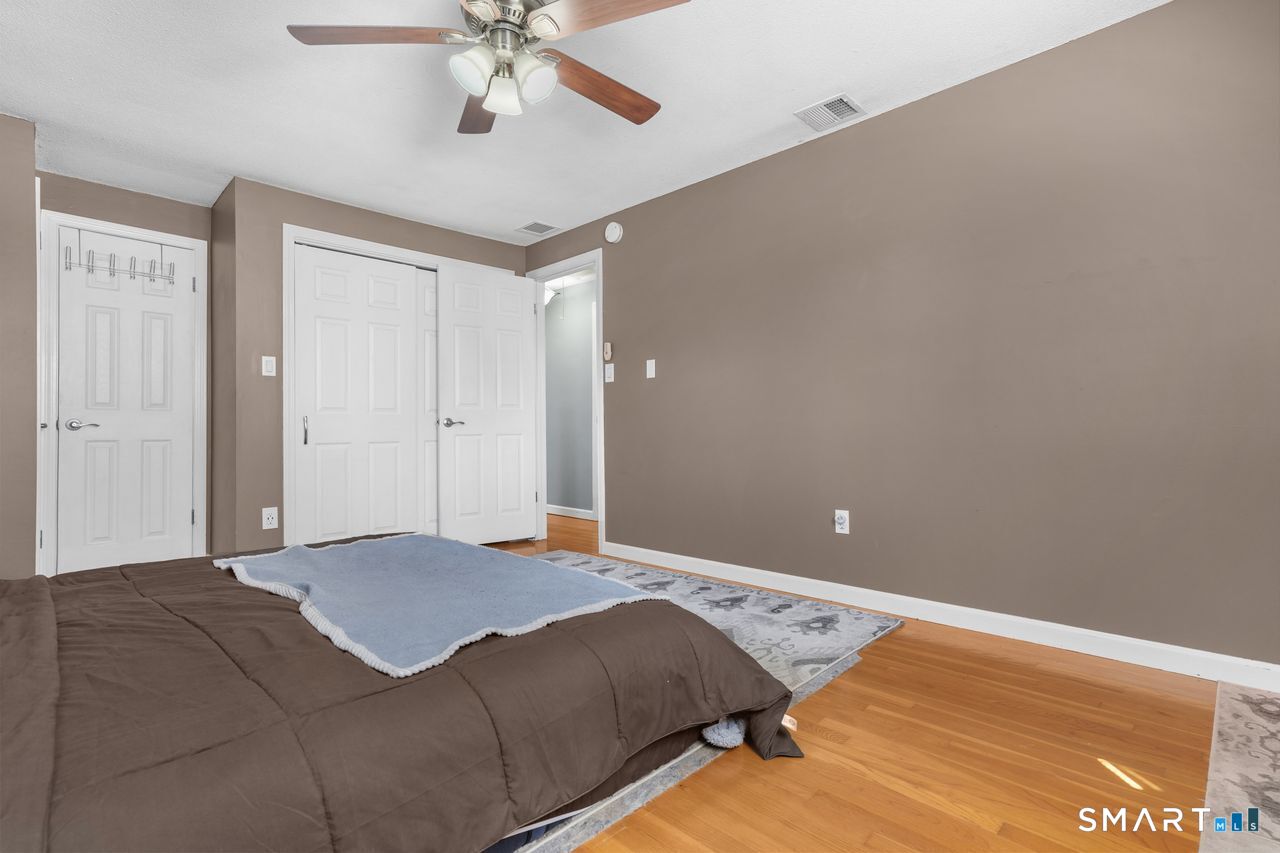 111 Ione Drive Meriden, CT 06450 - Photo 13 of 37 a bed room with a bed and a ceiling fan