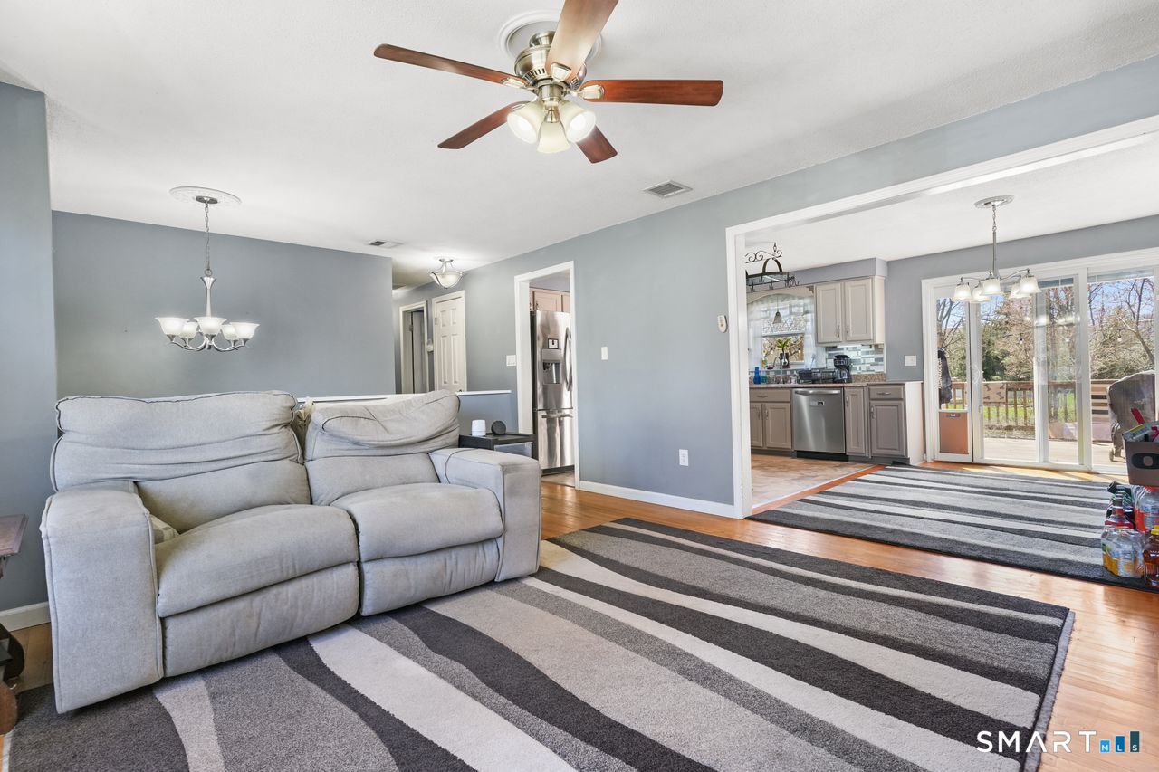 111 Ione Drive Meriden, CT 06450 - Photo 2 of 37 a living room with furniture and a chandelier