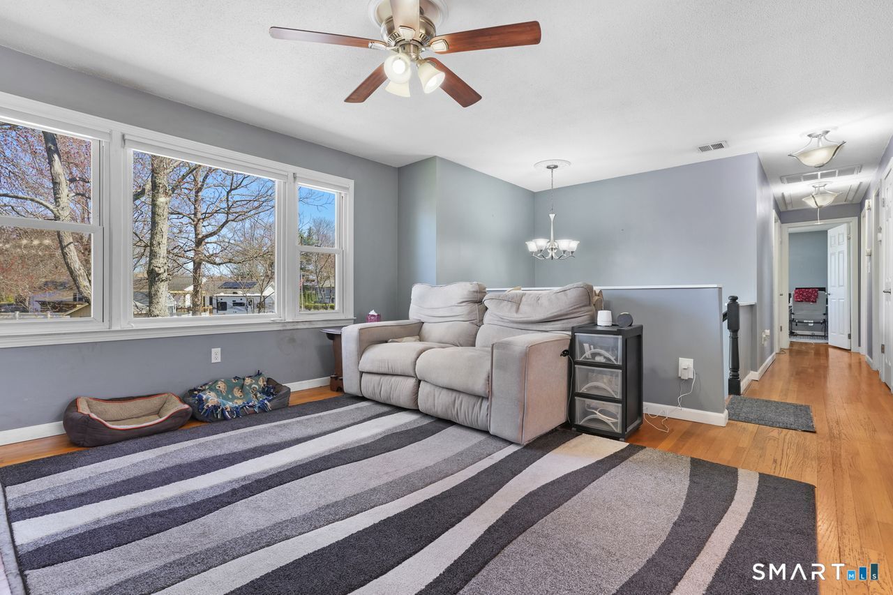 111 Ione Drive Meriden, CT 06450 - Photo 3 of 37 a spacious bedroom with a bed and wooden floor